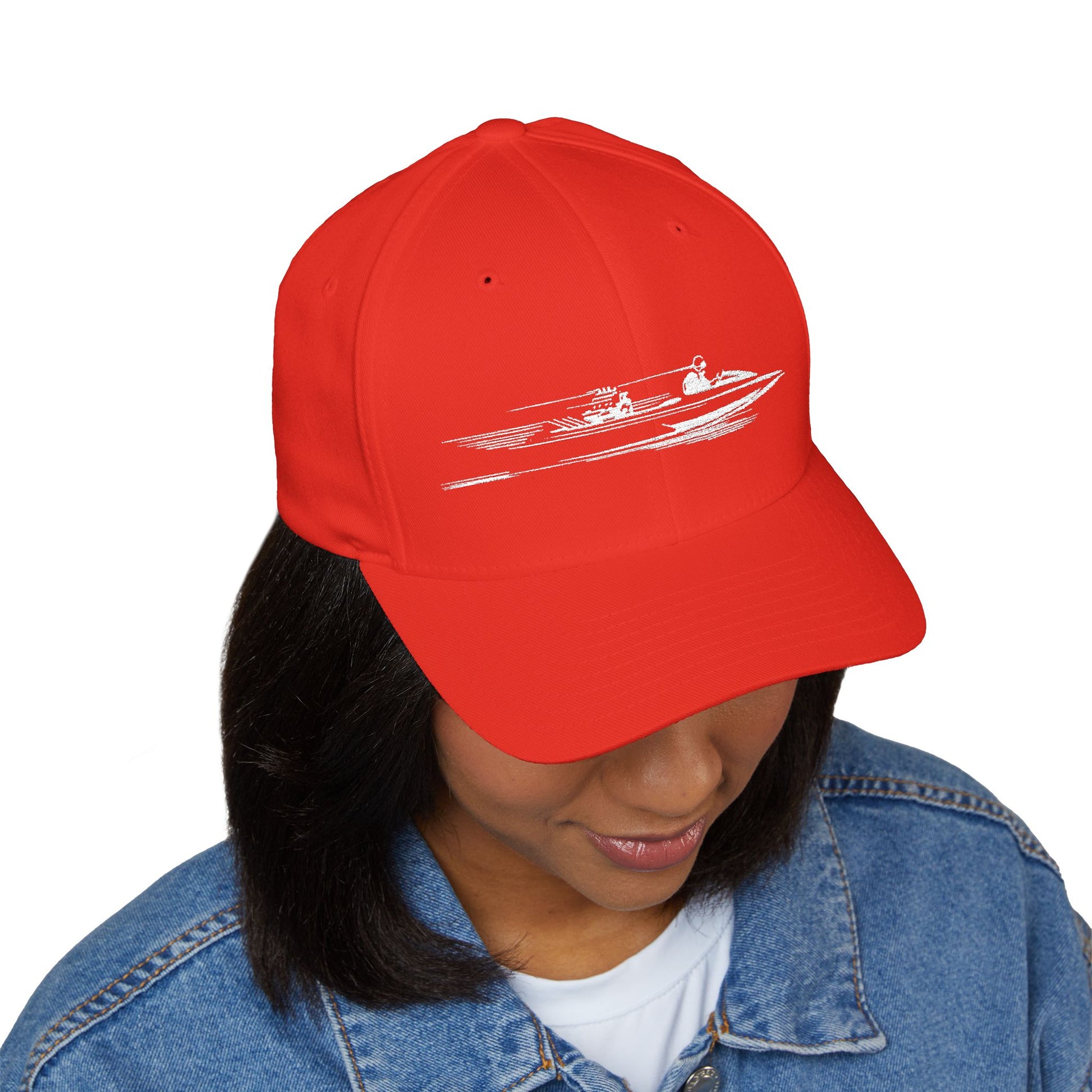 Red cap with a boat design worn by a person on a white background
