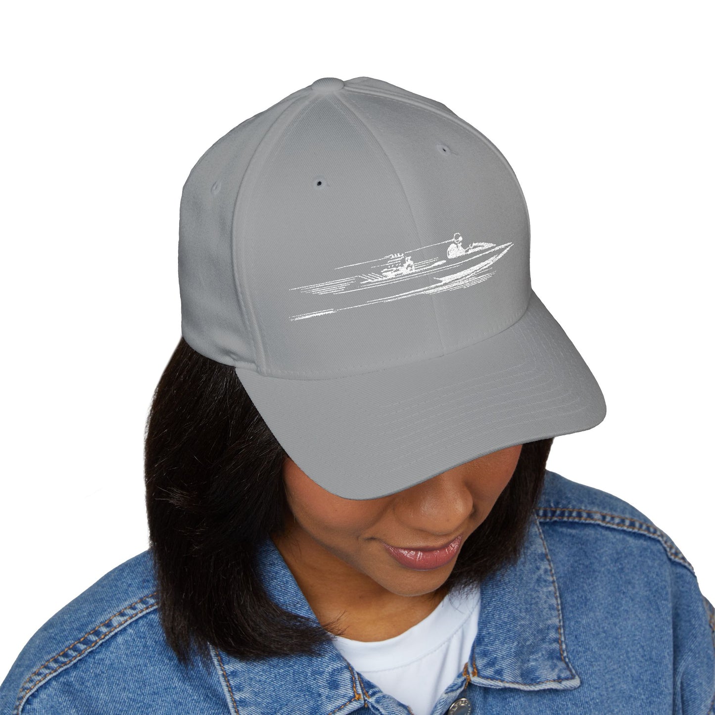Gray cap with a white graphic worn by a person on a white background