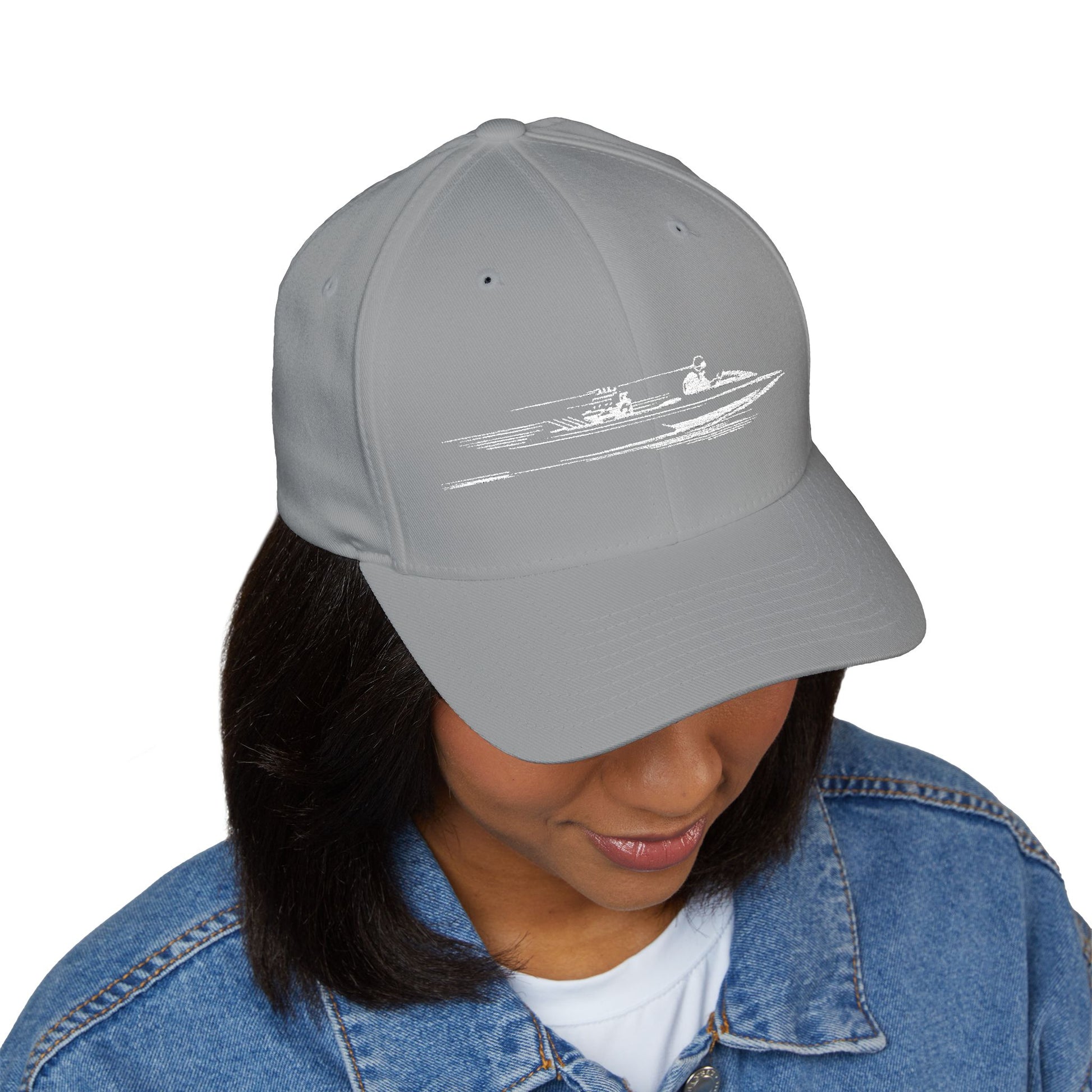 Gray cap with a white graphic worn by a person on a white background