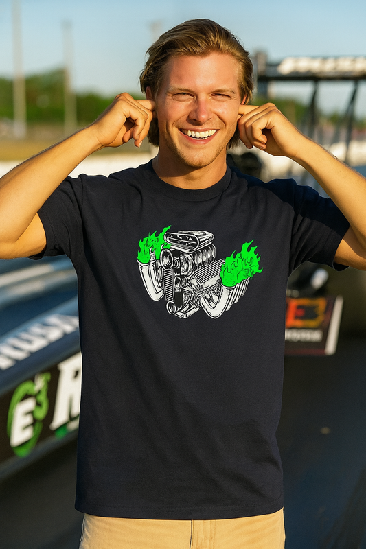 Man wearing a black bonspeed Rat Fink style t-shirt with a graphic design, standing in front of a car at a race track.