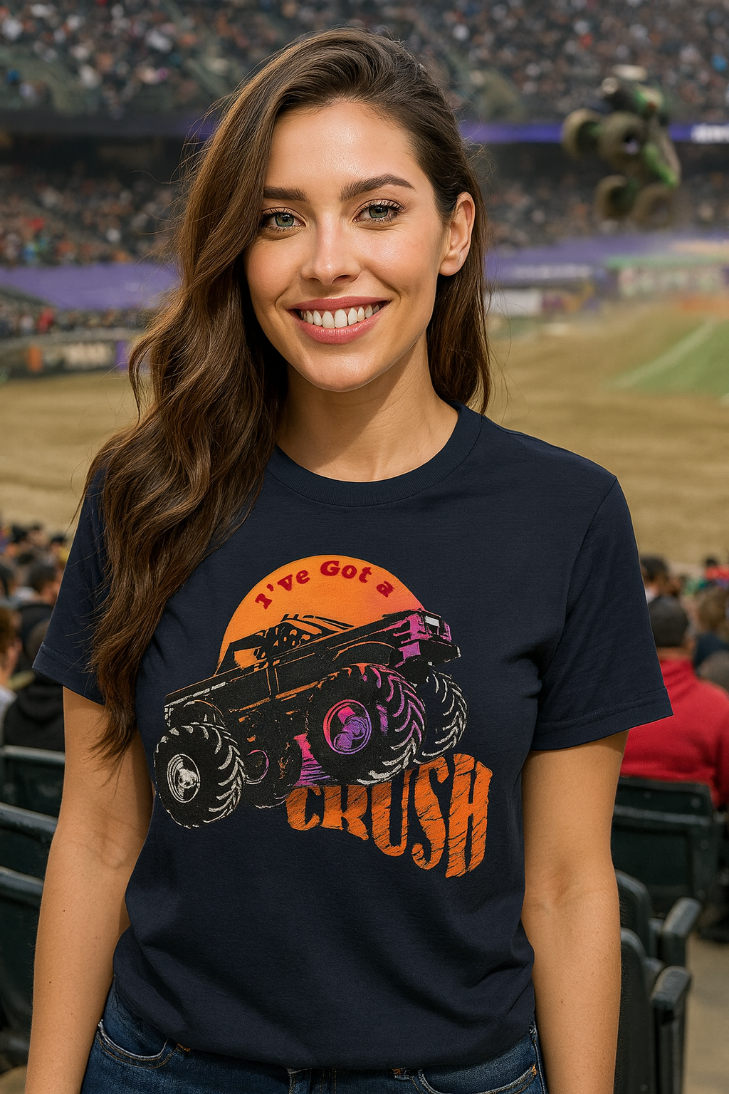 Woman wearing a navy blue bonspeed  t-shirt with a Monster Truck graphic design at a sports event.