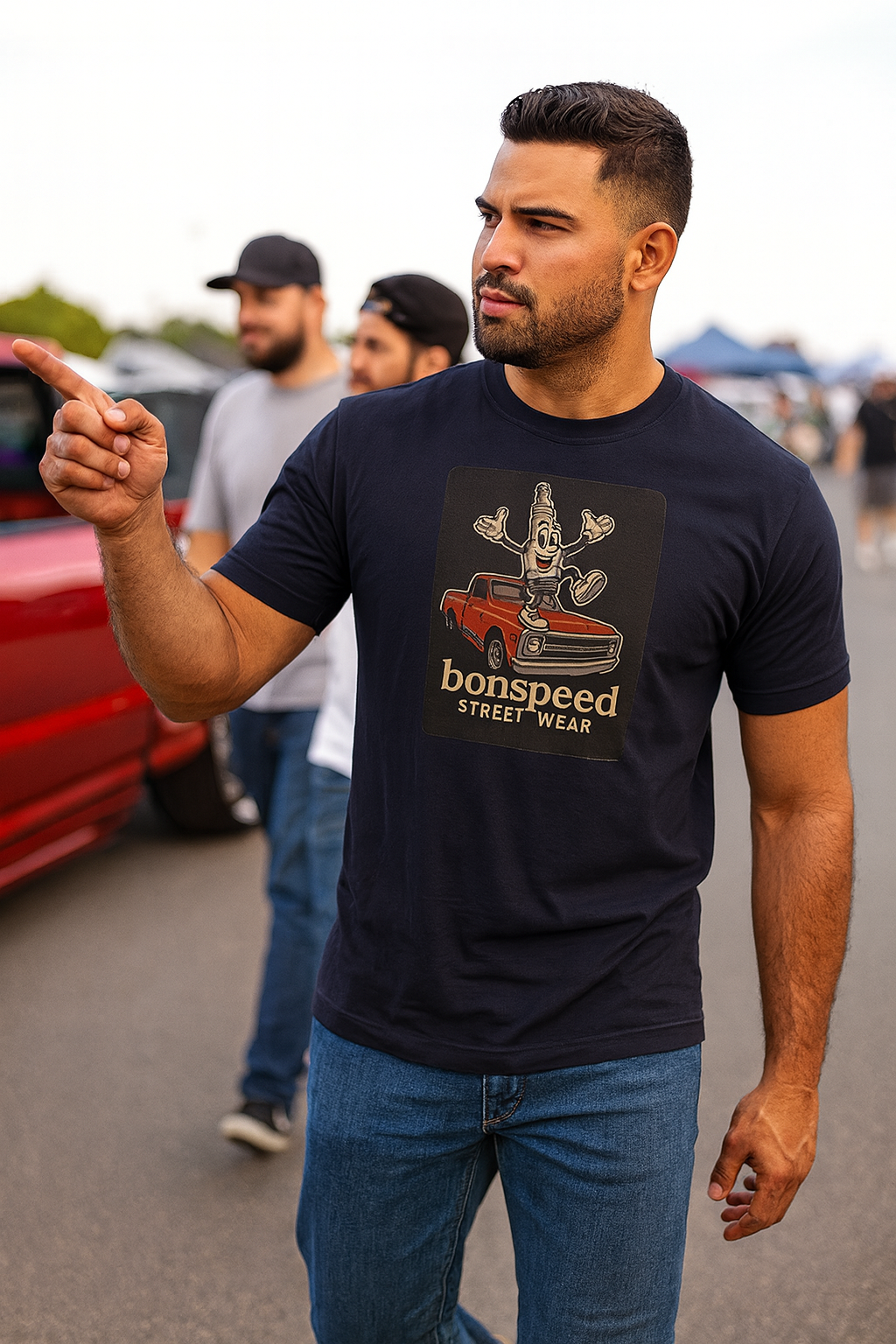 Man wearing a black t-shirt with 'bonspeed street wear' graphic design, pointing towards the camera.