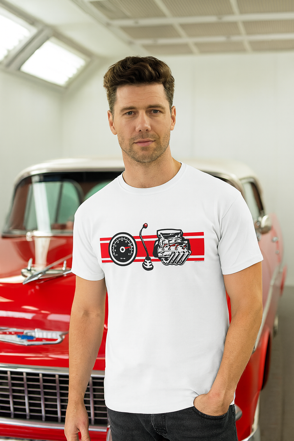 Man wearing a white bonspeed t-shirt with a graphic design in front of a red car.