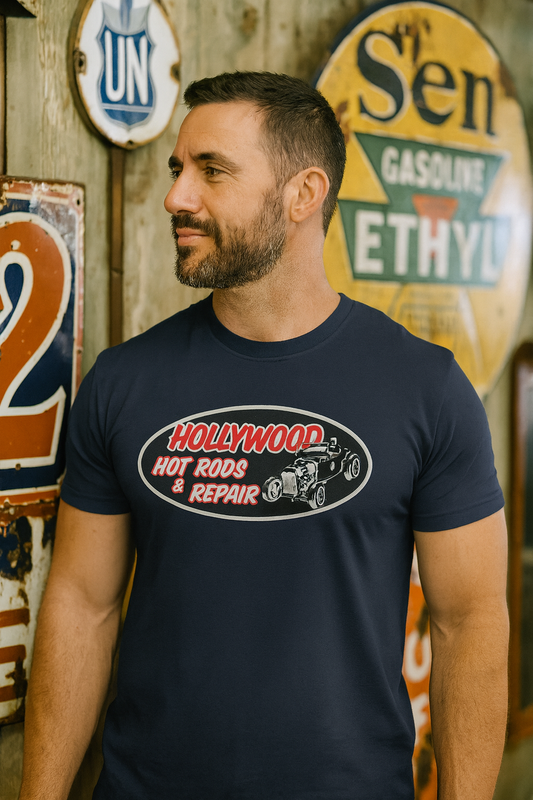 Man wearing a navy blue t-shirt with 'Hollywood Hot Rods Repair' graphic in front of vintage signs.