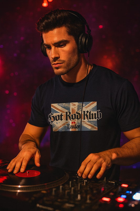 DJ operating turntables with a dark, blurred background wearing a bonspeed t-shirt