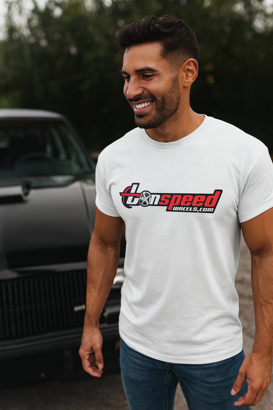 Man wearing a white bonspeed t-shirt with a logo and text, standing in front of a car.
