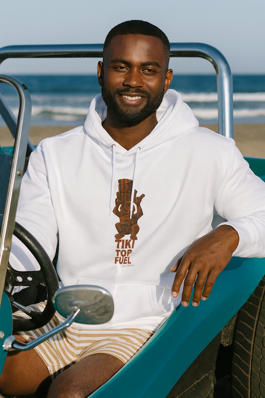 Man wearing a white bonspeed hoodie with a Tiki graphic design, sitting in a beach vehicle.