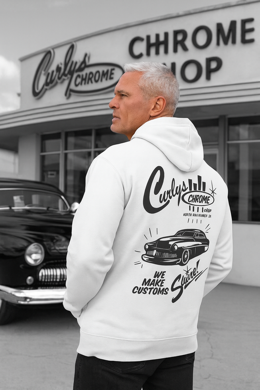 Man wearing a bonspeed 
hoodie with 'Curly's Chrome' branding in front of a car shop.