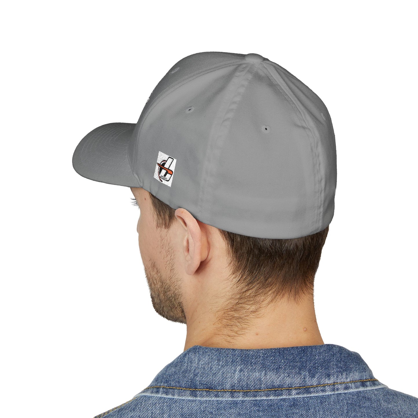 Gray cap with a small logo worn by a person on a white background